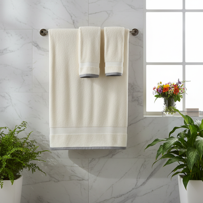 Towels hanging on wooden rack in bright marble bathroom with plants